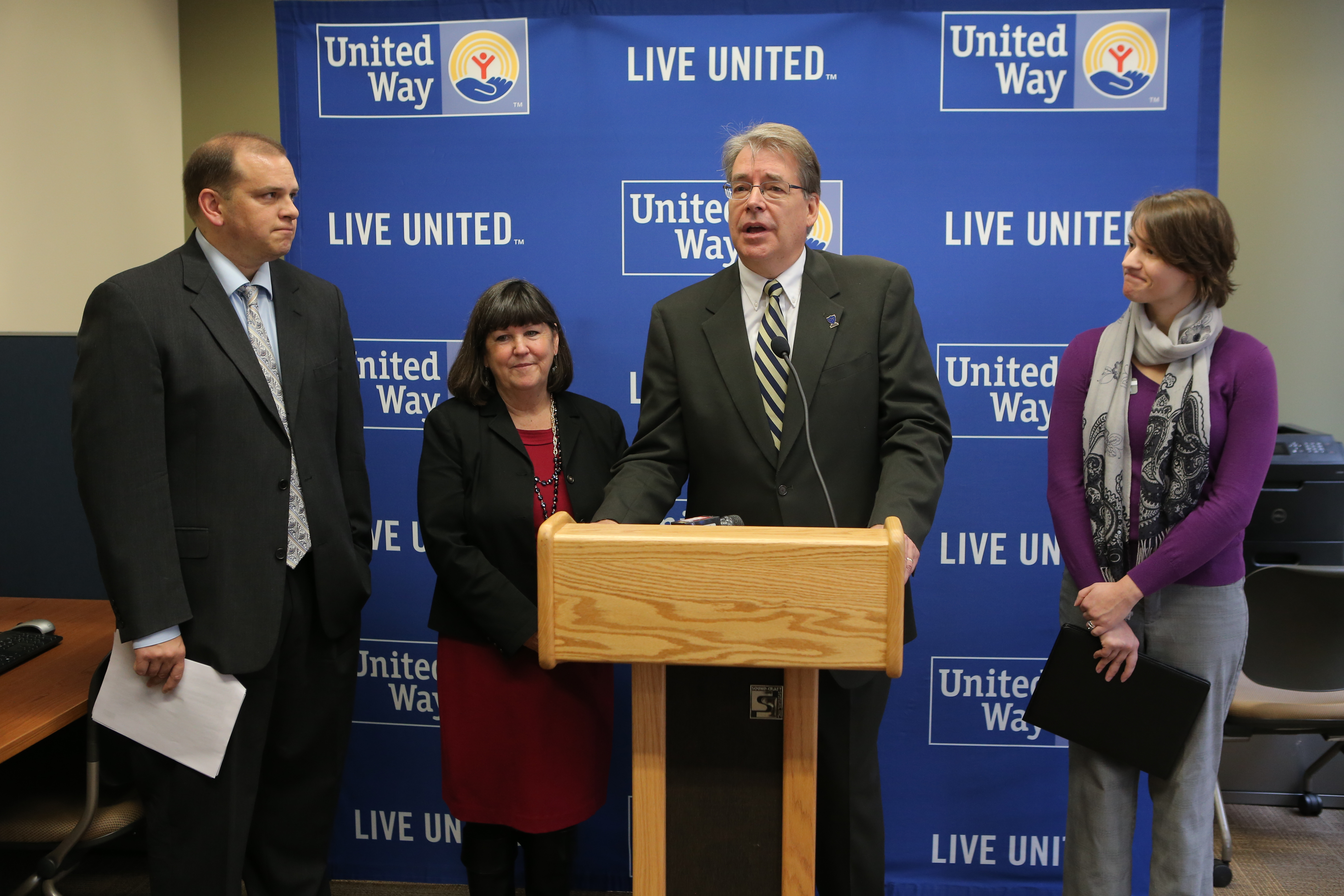 COBI Dean Gary Insch, at lecturn, spoke to the media about the Free Tax Preparation Program with, left to right, Lucas County Treasurer Wade Kapszukiewicz, Lucas County Commissioner Tina Skeldon Wozniak, and United Way Program Manager of the Free Tax Preparation Program Toni Shoola. 