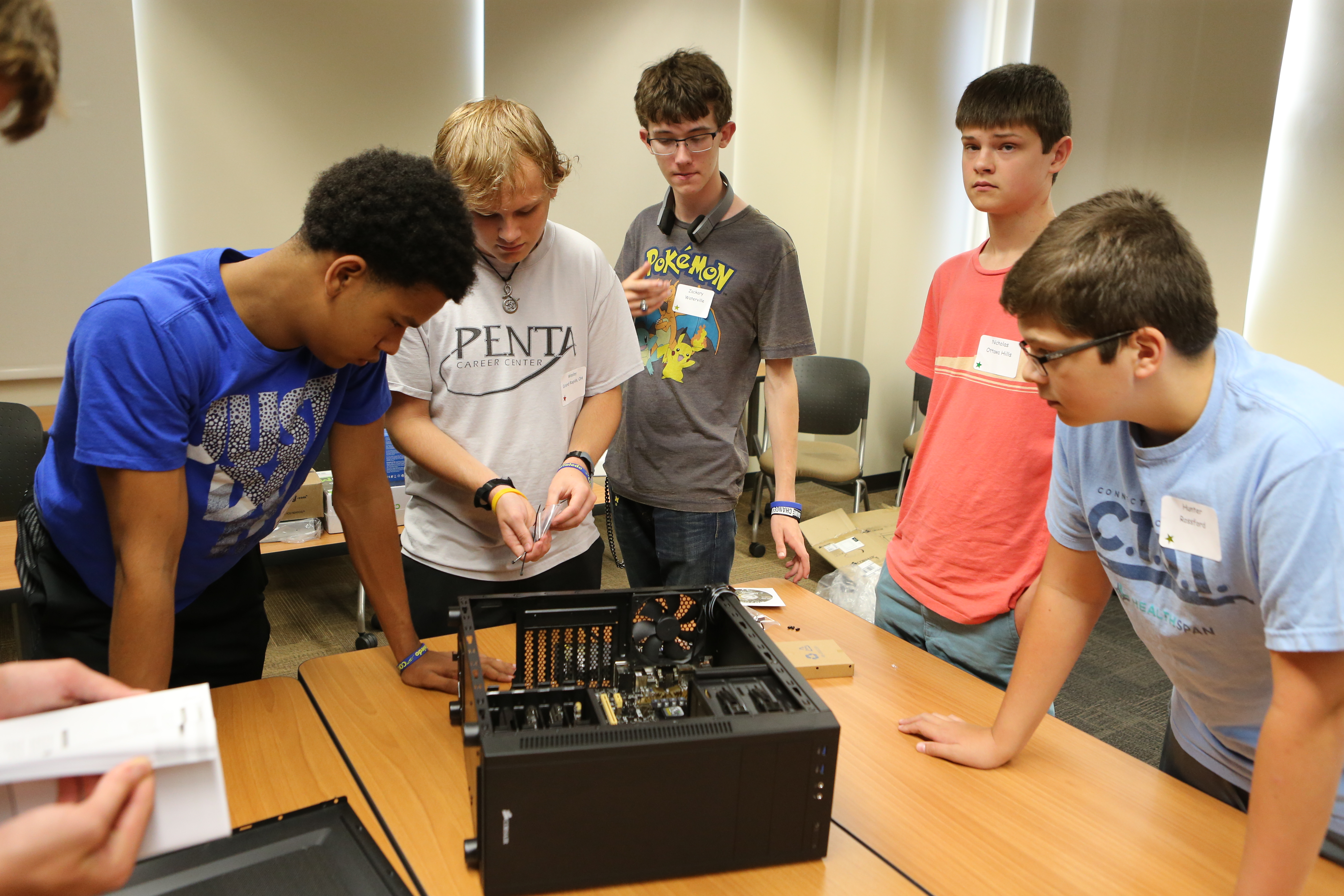 Tech Camp students inspect PC components