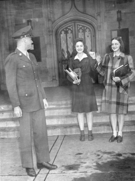 WW 2 soldier with two young women in front of University Hall.
