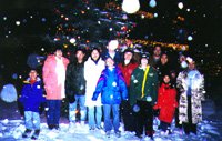 Students have fun in the snow with their family.