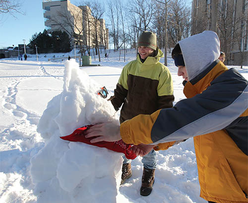 Students building a snowman