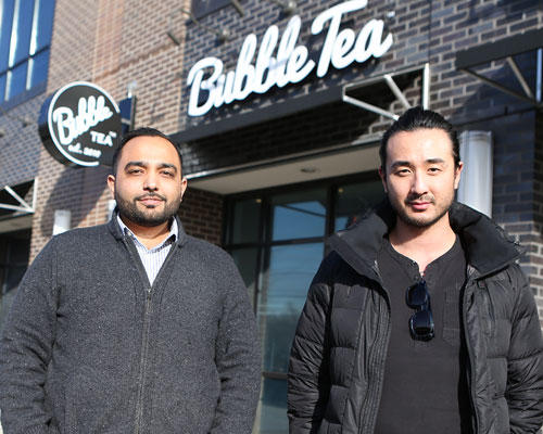 Hochan Jang and Prakash Karamchandani standing outside of Bubble Tea restaraunt