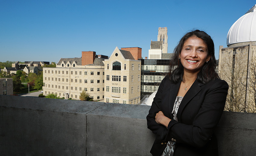 Rupali Chandar, Ph.D., standing on the roof of a building on UToledo's campus in the daytime