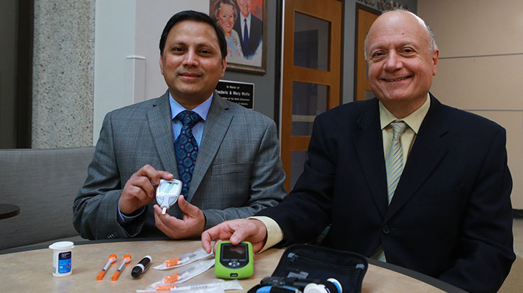 Dr. Shahnawaz Imam and Dr. Juan Jaume with an array of diabetes management tools.