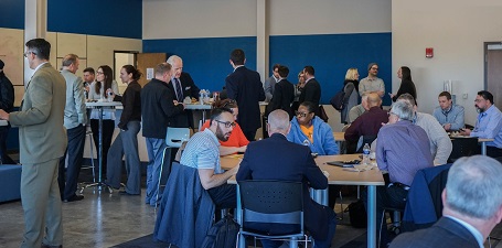 Group of people networking at a business UToledo Business Incubator Coworking event