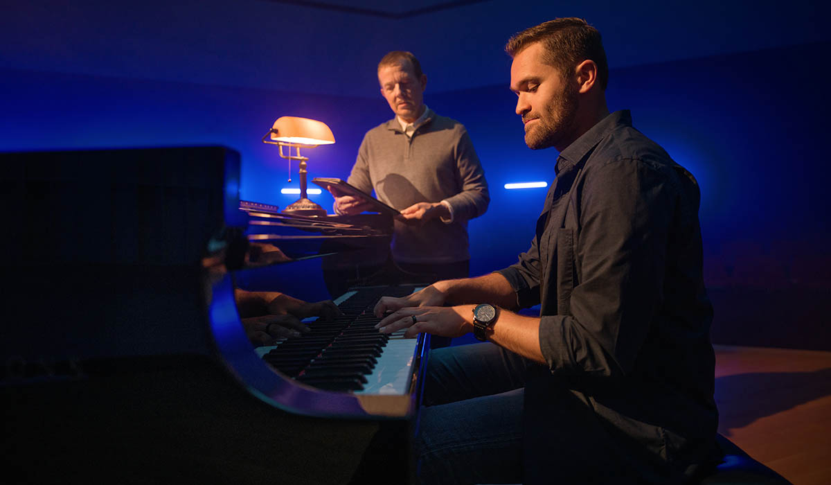 student receiving instruction on piano