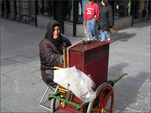 A Gypsy woman plays her portable piano on the streets of Madrid, Spain