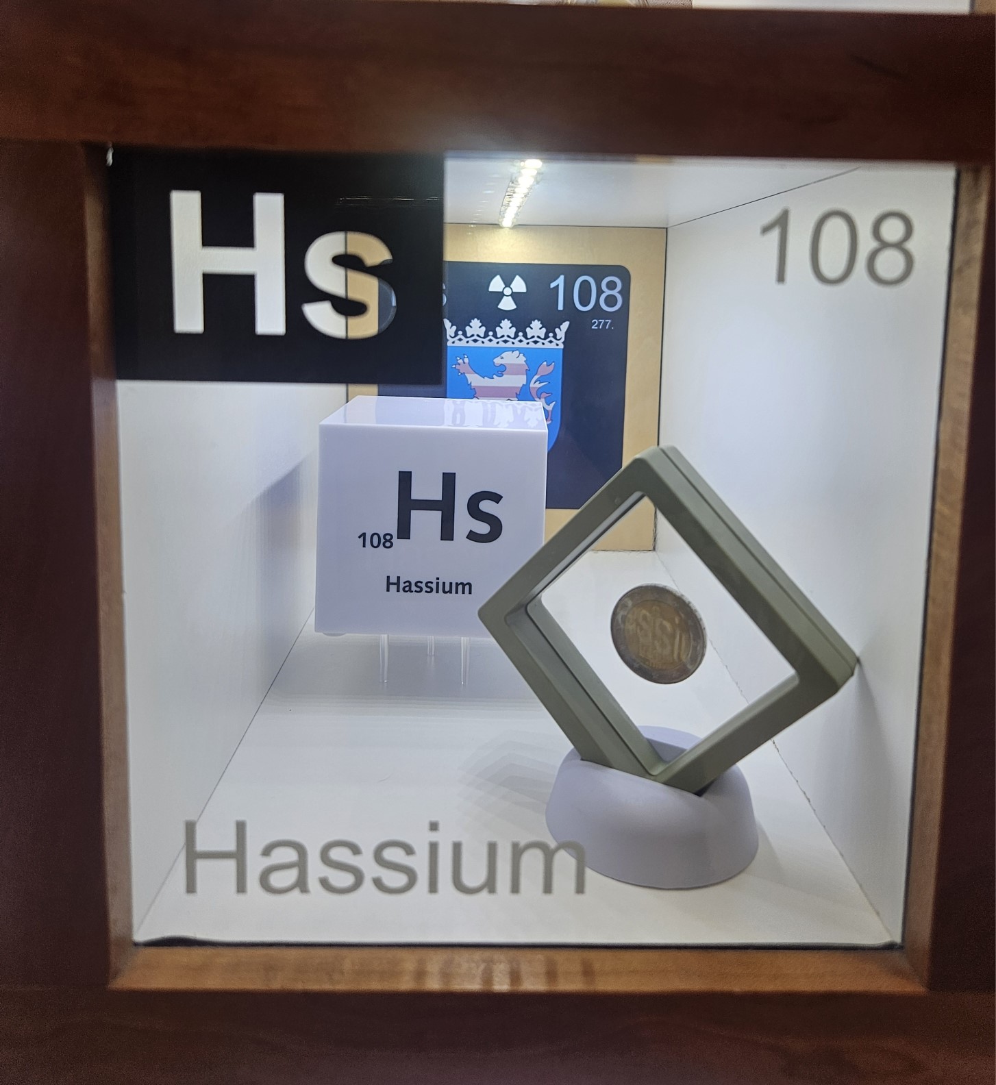 Hassium display box with a coin