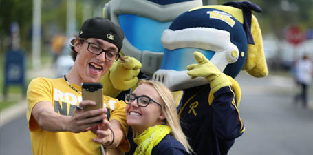 Students taking a selfie with Rocky and Rocksy