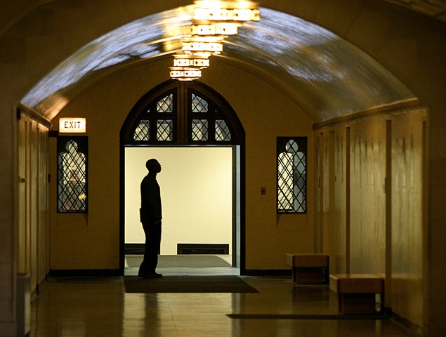 Photo of person standing in hallway of University Hall