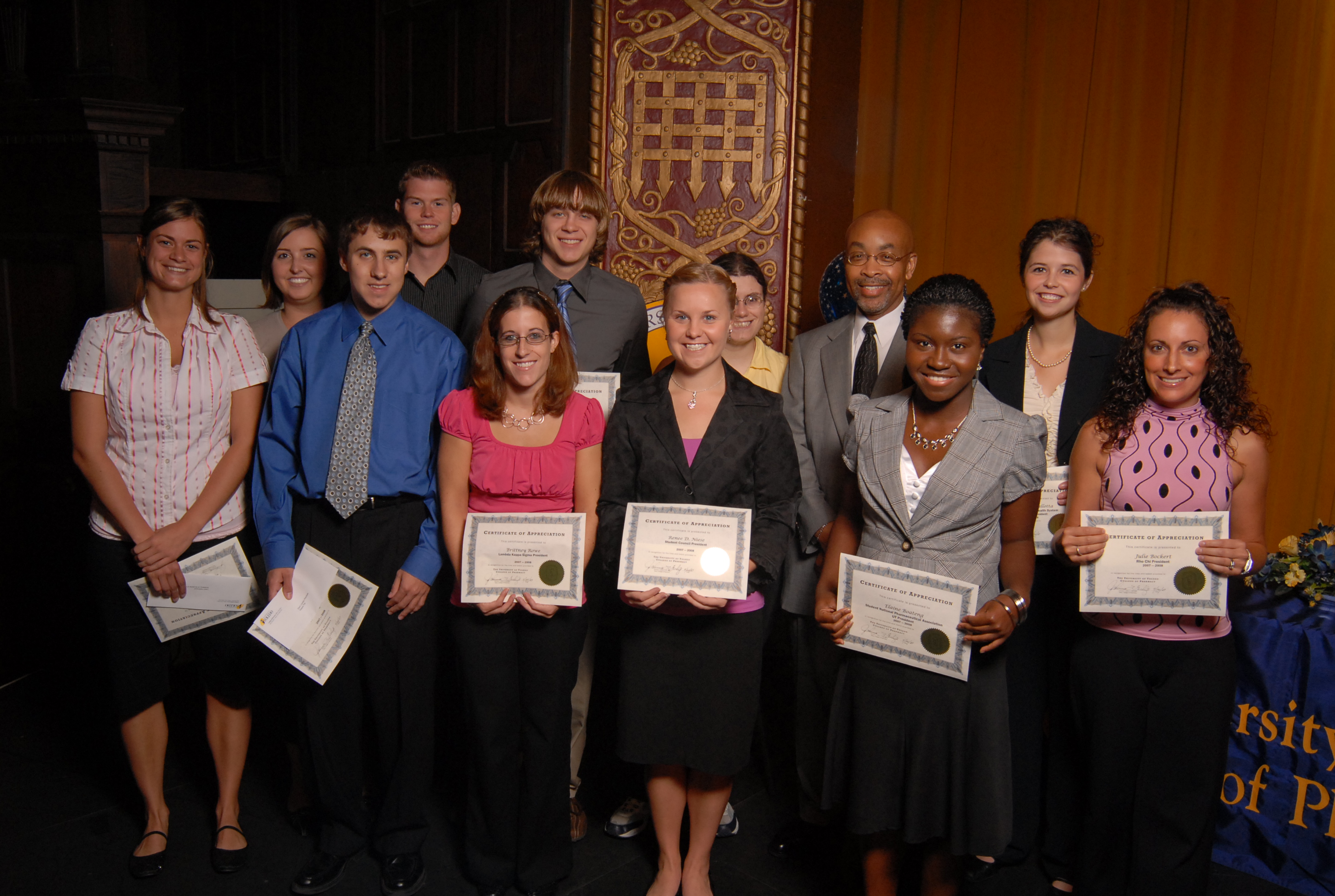 photo of students with scholarship certificates