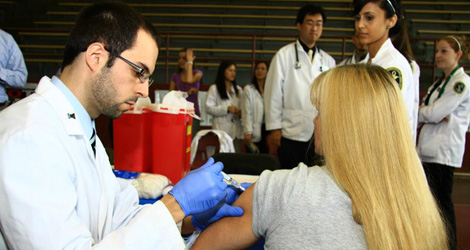 student giving vaccination image