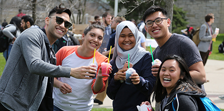 Students holding smoothies in Centennial Mall at student event