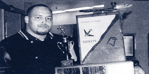 A black and white photo of a man posing with the peace pipe award
