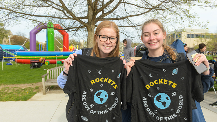 two student showing off Rockets are out of this world t-shirts
