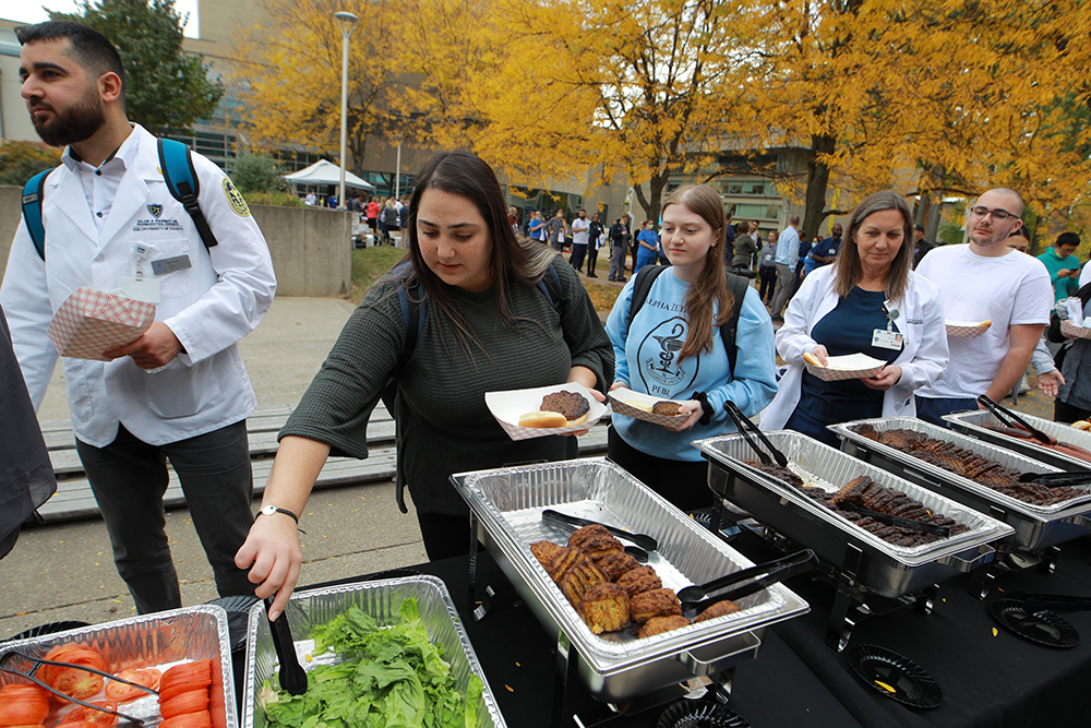 Students wait in line to get food at the Founder's Day BBQ