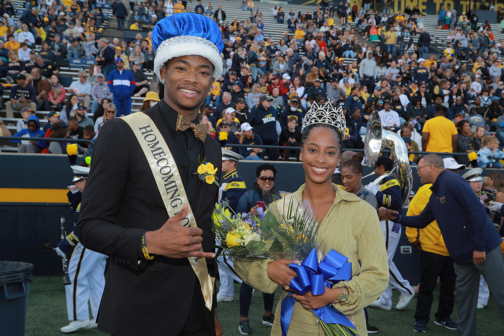 The Homecoming Queen and King smile at the camera as they poste in the Glass Bowl during the Homecoming football game