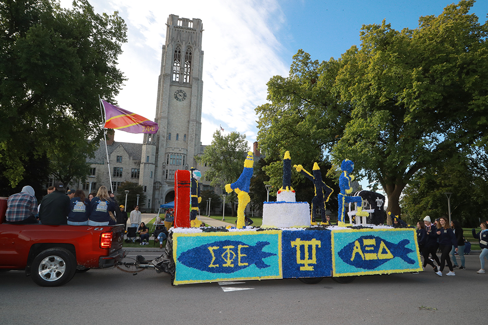 A float from Greek organizations in the Homecoming Parade passes in front of University Hall