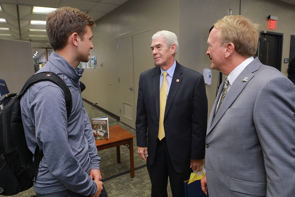 A UToledo student speaks with Dr. Postel and Randy Gardner