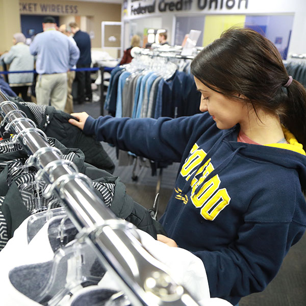 A UToledo student shopping for Rocket gear