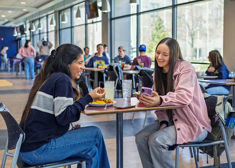 two students talking in the dining hall 