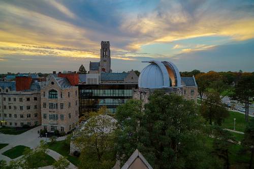 aerial photo of campus buildings as the sun sets.