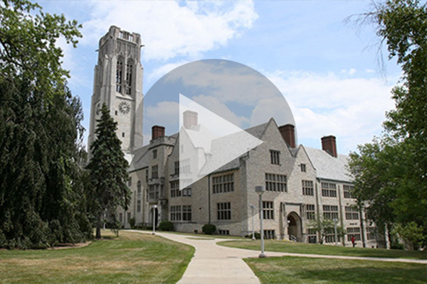 A photo of UToledo's campus with a play button graphic overlaid on top of it