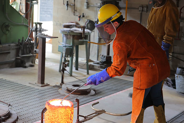student working on metal works project