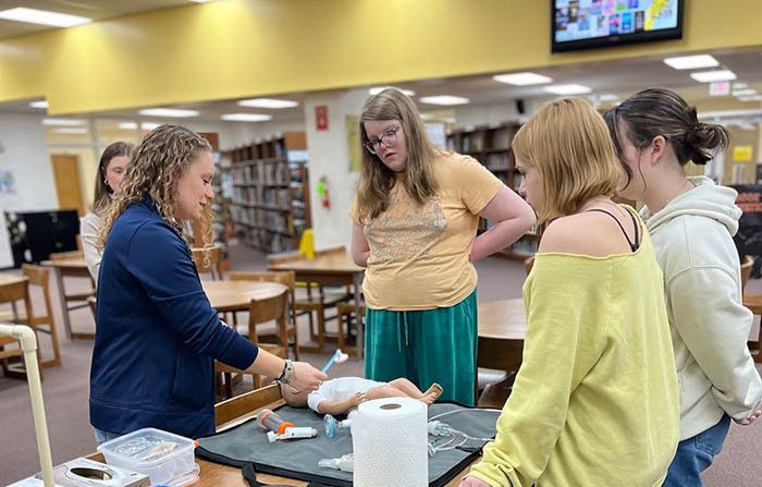 respiratory care student shares care information with high school students