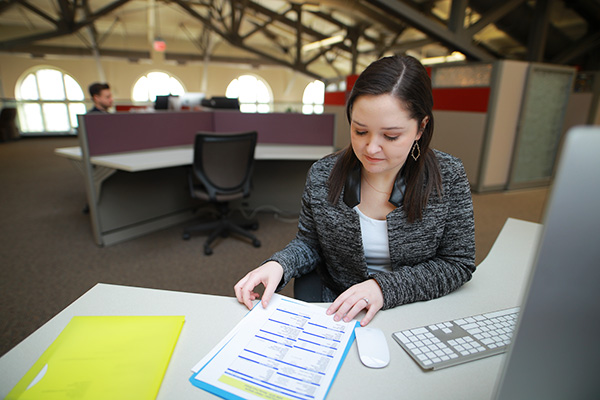 Student working at a desk in front of a computer