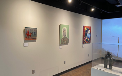 Carlson Library Art Showcase - wide view of wall with paintings