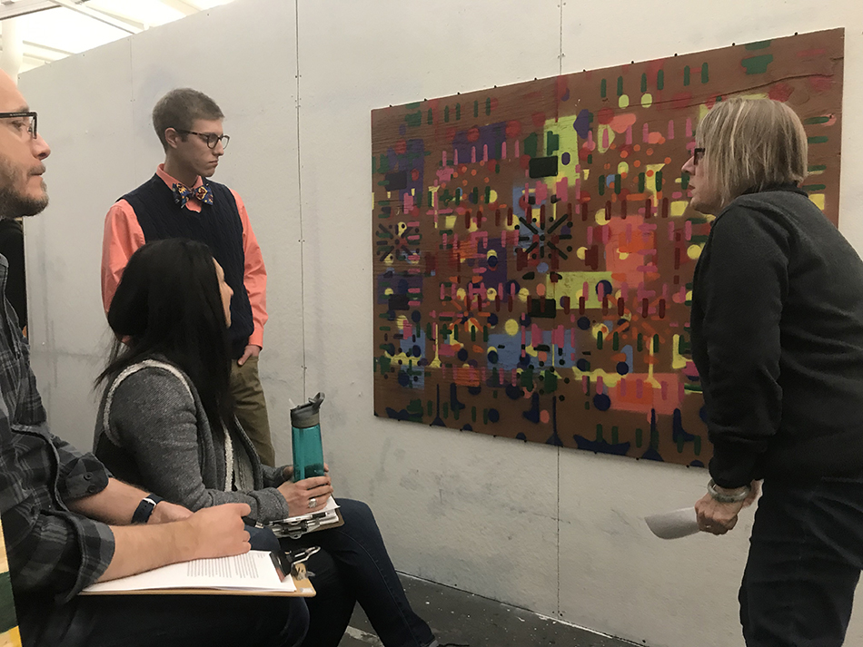 Barbara Miner, UToledo chair of the Department of Art, discusses an artwork with students