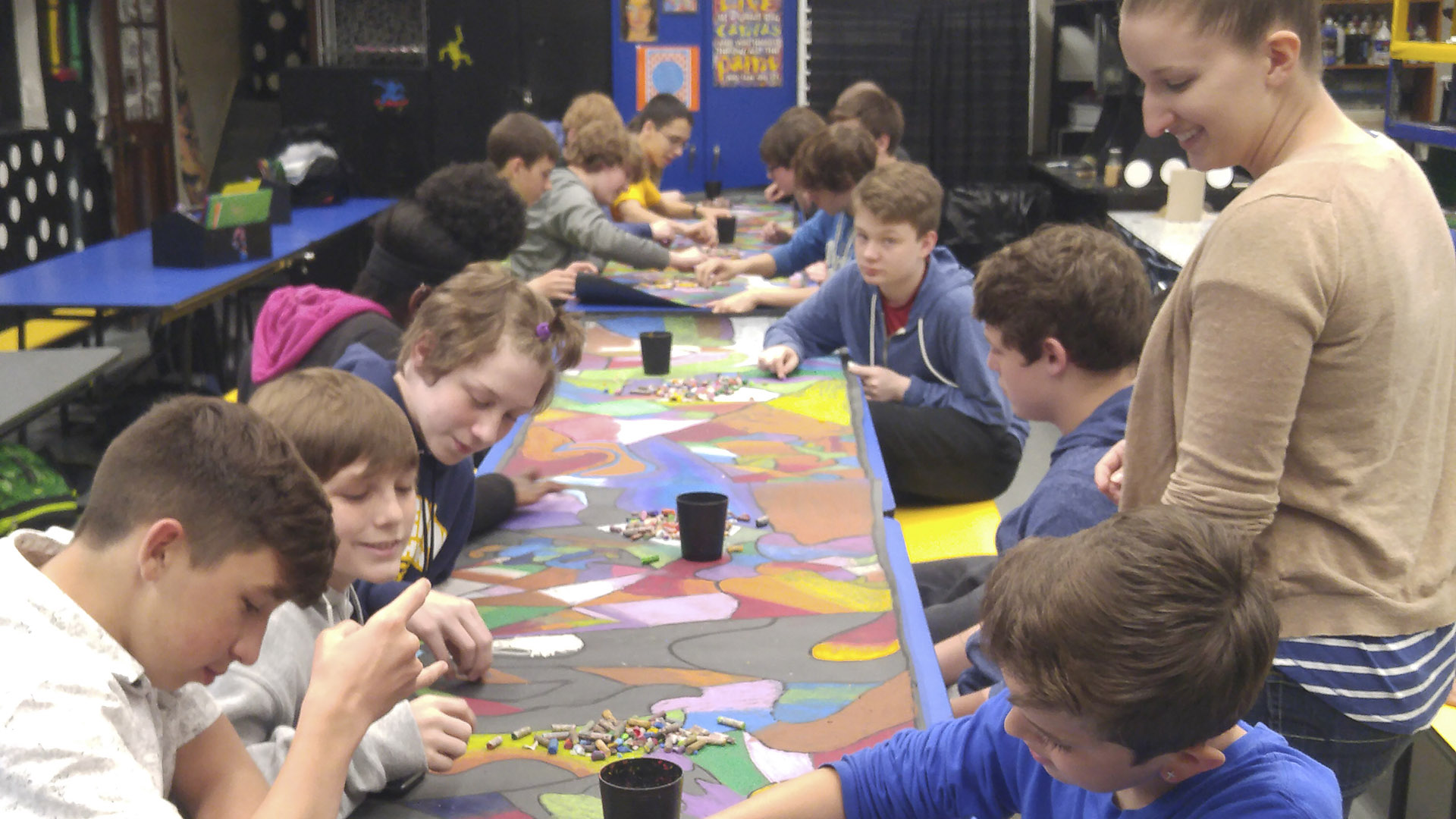 student art teacher and students making art at tables