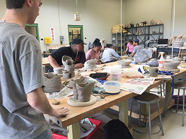 ceramics students working