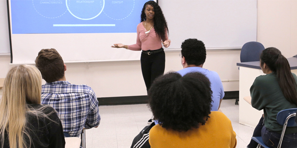 Student presenting to a classroom of students