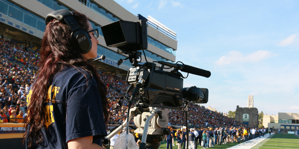 Student filming a Toledo Rockets football game