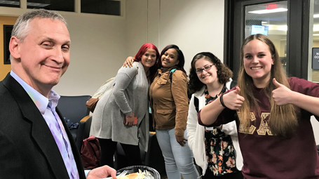 Professor Jim Ferris pictured with students giving two thumbs up