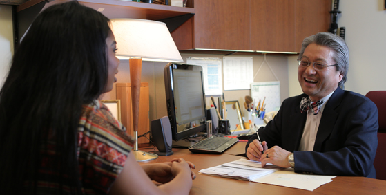 student talking with an advisor about their classes