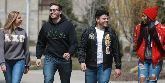 four students walking together on campus