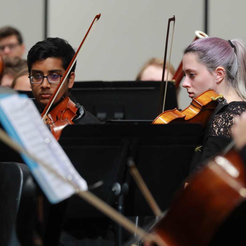 Photo of UToledo students playing violins