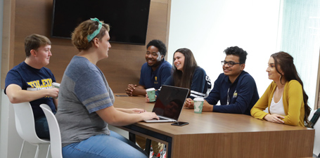 Students talking in a common area on campus