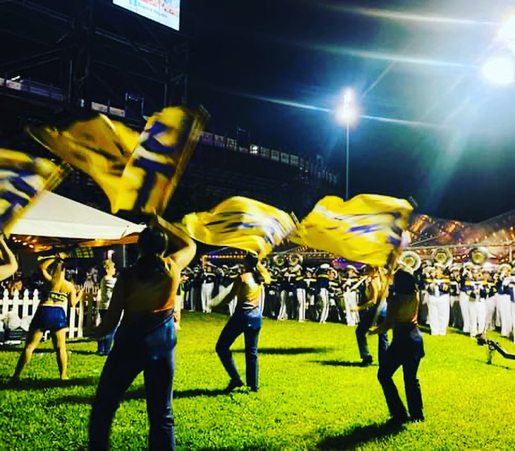 color guard spinning flags at pregame party