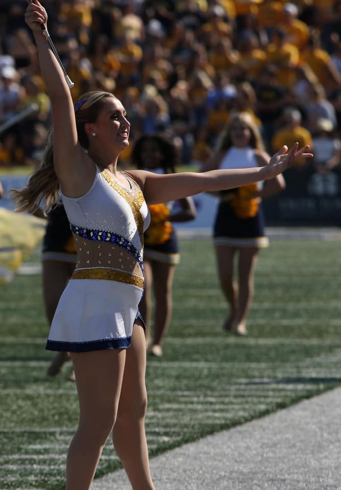 majorette twirling on football field