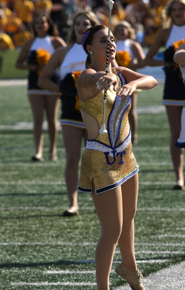 majorette twirling on football field