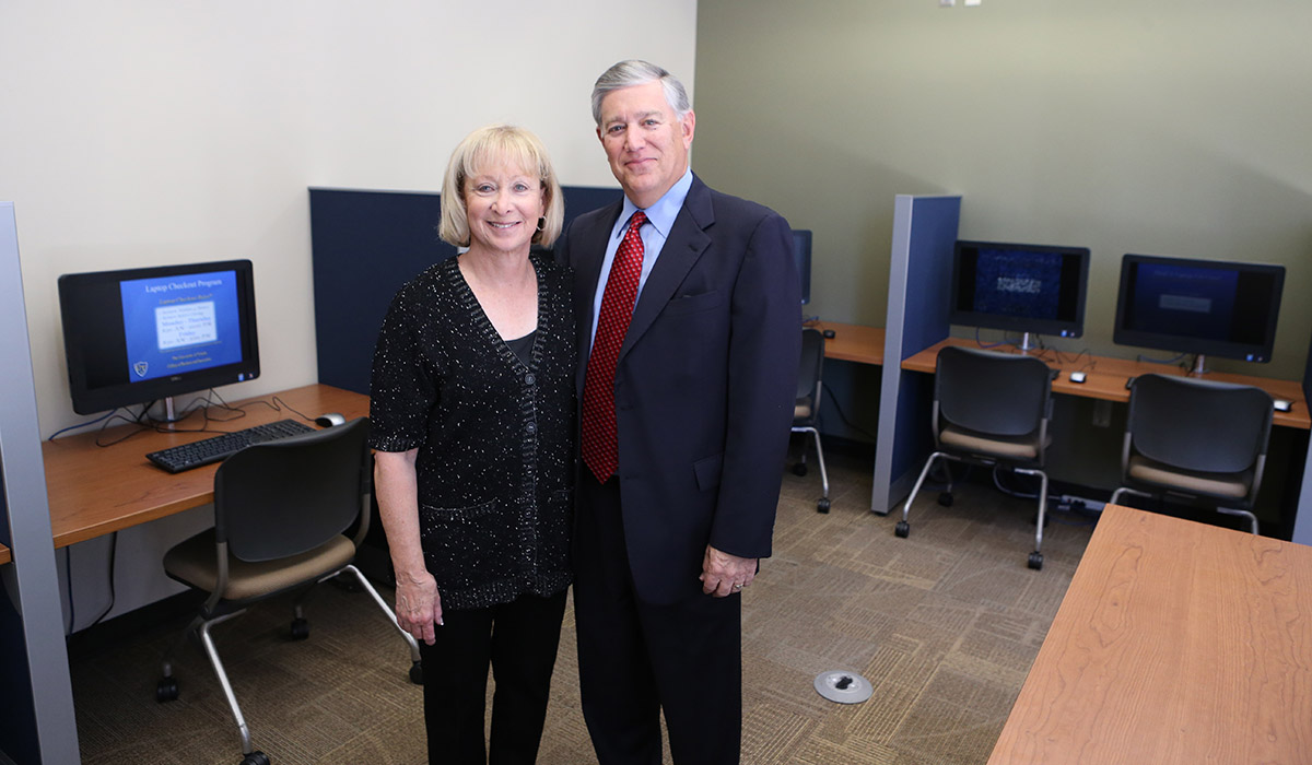 Alan Barry and his wife Karen standing inside the Alan Barry Accounting Lab in the college of business