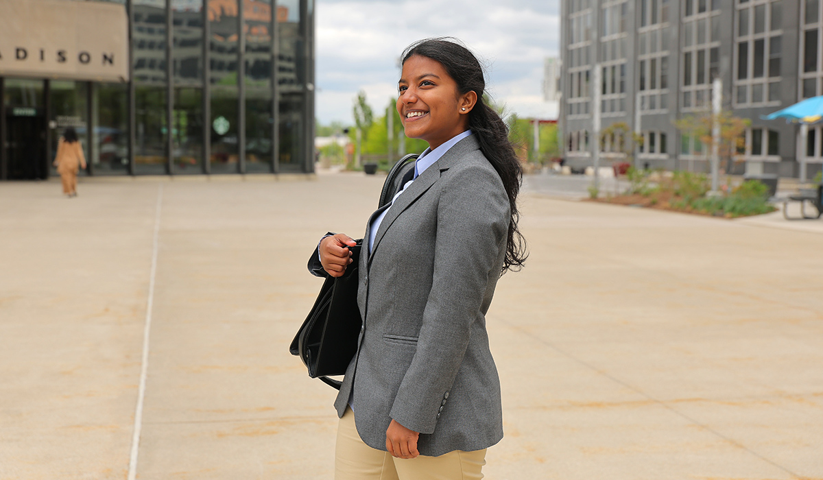 College of business student dressed in professional clothing walking to her internship in downtown Toledo.
