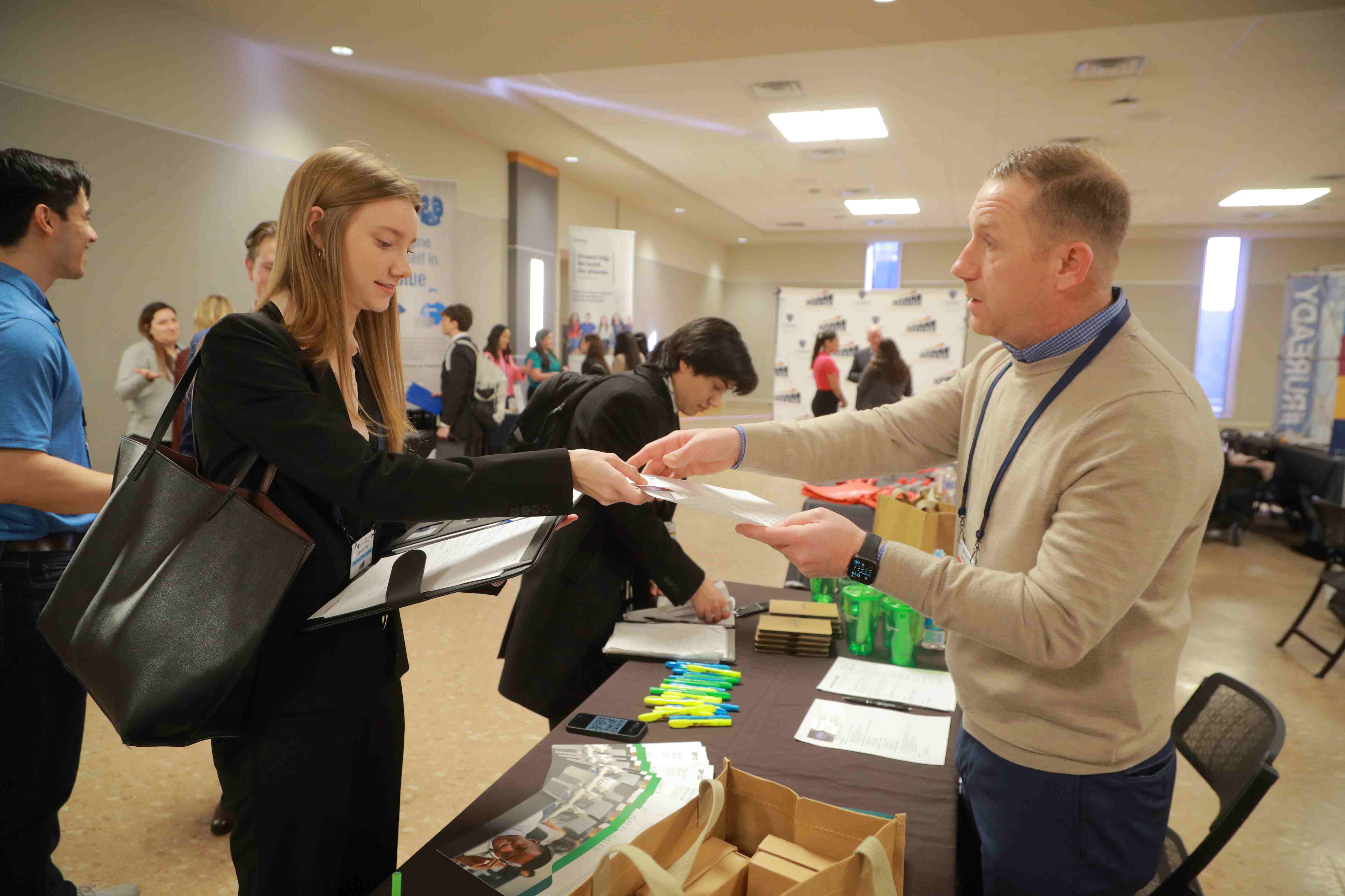 career fair student handing resume