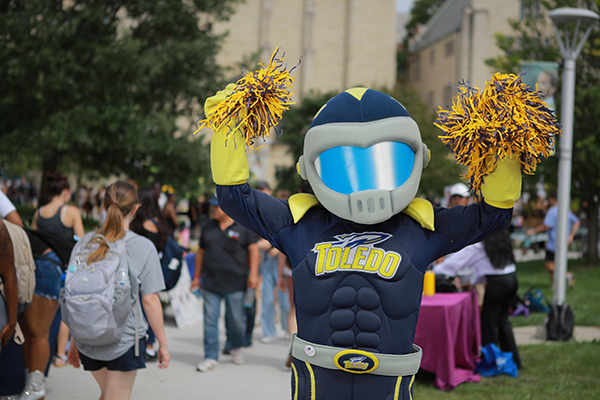 Rocky standing in centennial mall cheering on students as they walk by