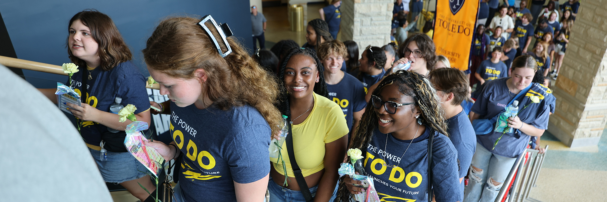 A group of students walking up stairs in savage arena at the new student convocation