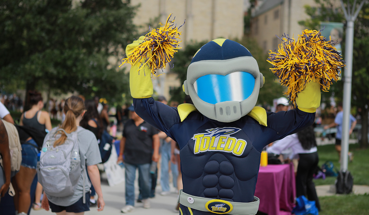 Rocky standing in centennial mall cheering on students as they walk by